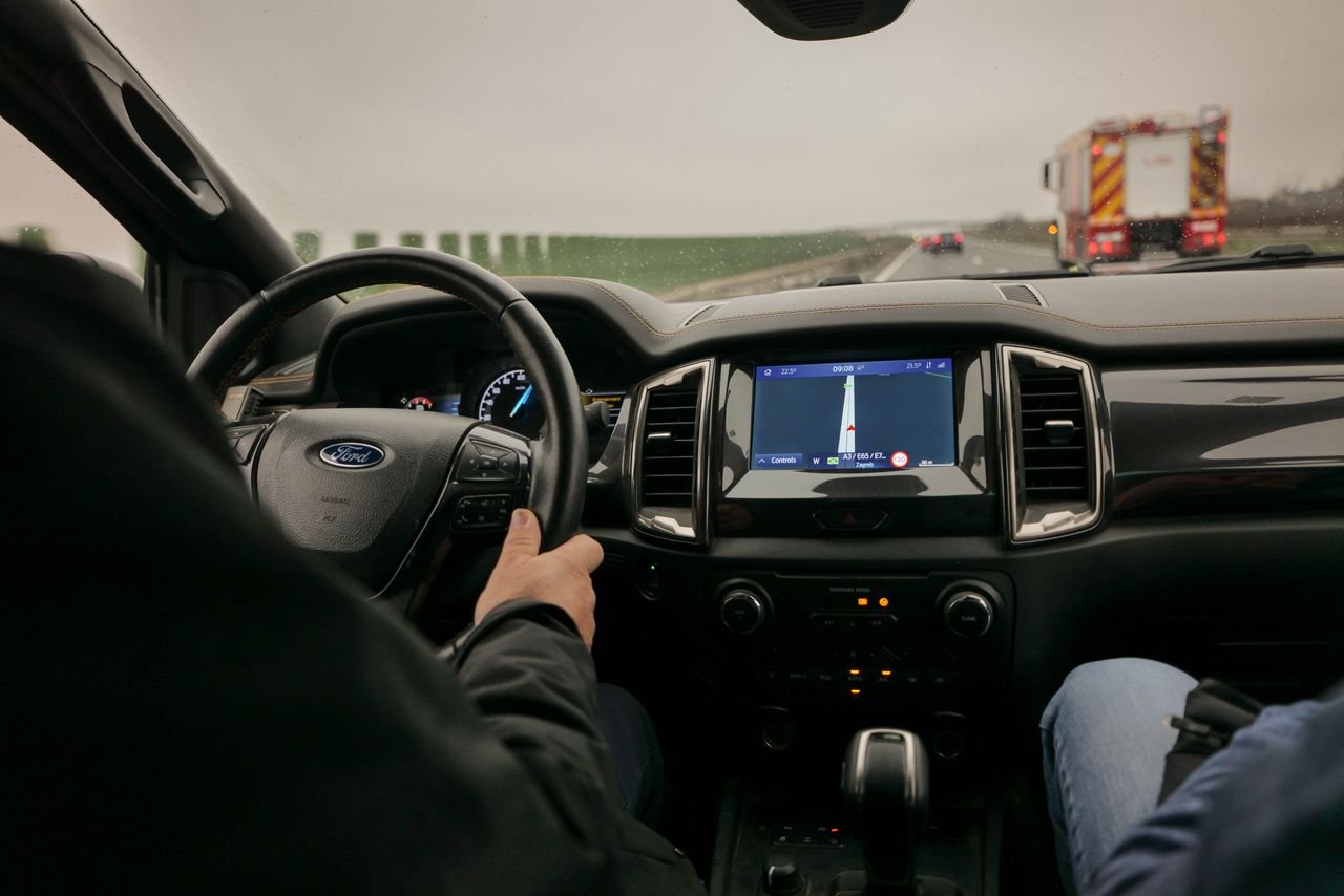 who-we-are Interior view of driving a Ford with navigation system on a highway near Zagreb, Croatia.