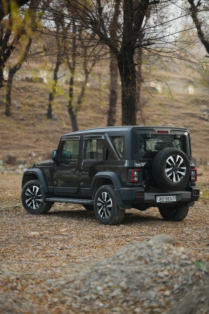 Crafting Captivating Headlines: Your awesome post title goes here Mahindra Thar SUV parked in a scenic autumn forest, showcasing rugged design and natural beauty.